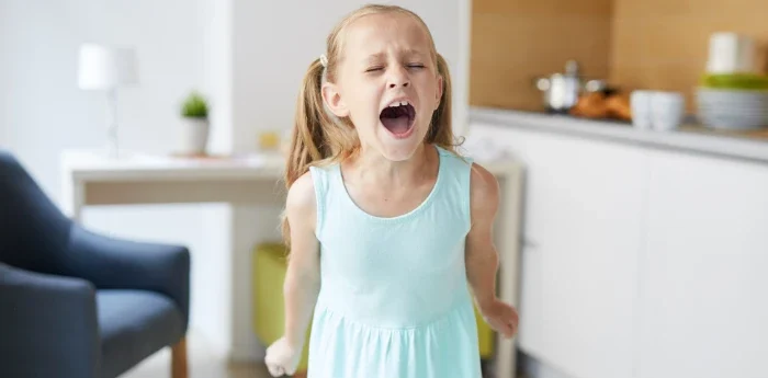 How Poor Sleep and Breathing Affect Focus and Mood - Atkins & Anderson DDS image of a tired, upset child at home showing behavioral changes.