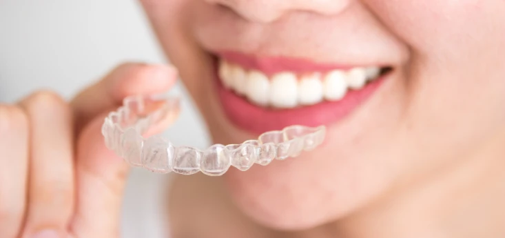 Invisalign candidate signs for clear aligners in College Station