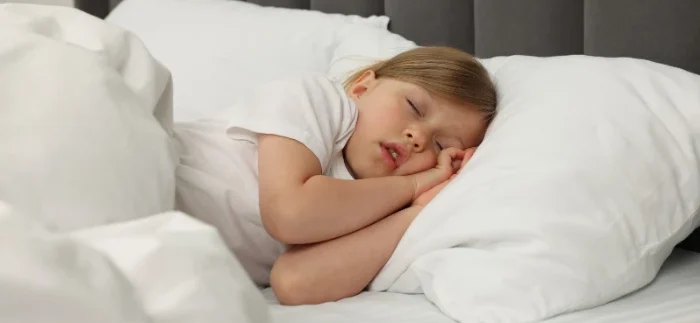 Sleeping child showing why kids shouldn’t snore and the importance of airway health
