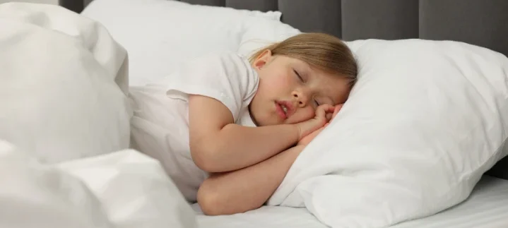 Sleeping child showing why kids shouldn’t snore and the importance of airway health